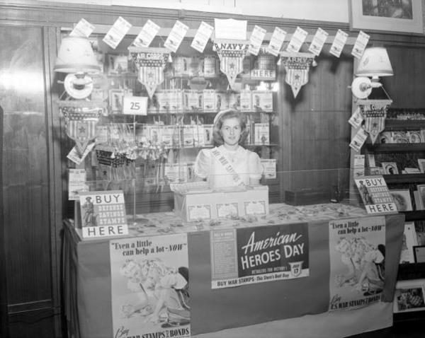 A McLellan's employee surrounded by vintage ads. Image courtesy of the State Archives of North Carolina.