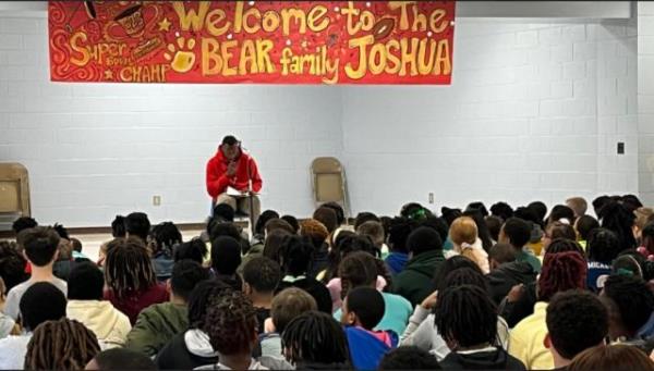 Super Bowl Champion Joshua Williams reads the book 'Oh, The Places You'll Go! by Dr. Seuss' to students at Loyd Auman Elementary School in Fayetteville.