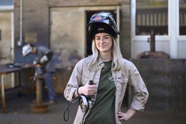 Tennessee College of Applied Technology Nashville student Abbey Carlson poses during welding class Wednesday, April 13, 2023, in Nashville, Tenn. While almost every sector of higher education is seeing fewer students registering for classes, many trade school programs are booming with young people who are choosing trade school over a traditio<em></em>nal four-year degree. (AP Photo/John Amis)