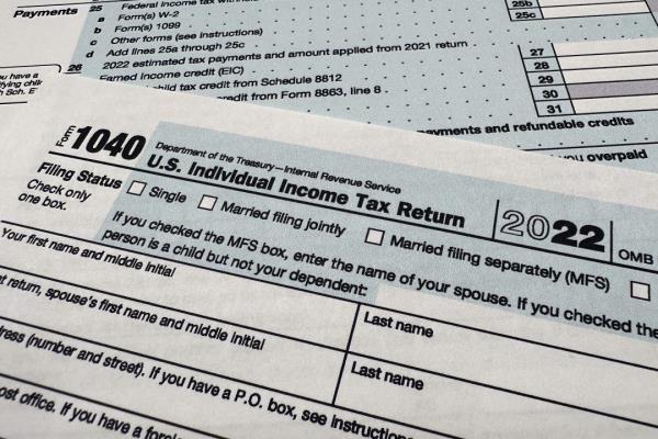 The Internal Revenue Service 1040 tax form for 2022 is photographed, Monday, April 17, 2023. The IRS says it has answered 2 million more calls this tax filing season than a year ago, with the average phone wait time now at four minutes. That's down co<em></em>nsiderably from 27 minutes for the 2022 tax season. (AP Photo/Jon Elswick)