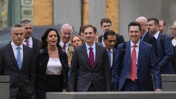 Representatives of Dominion Voting Systems arrive at the justice center for the Dominion Voting Systems' defamation lawsuit against Fox News, Tuesday, April 18, 2023, in Wilmington, Del. (AP Photo/Julio Cortez)