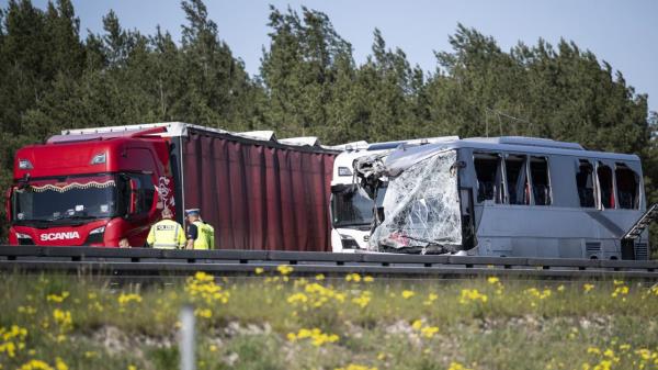 A polish coach stands damaged on the A12 highway after a serious accident in Dannenreich, near Berlin, Germany, Tuesday, May 9, 2023. A highway collision between a long-distance Polish bus and a truck has injured dozens of people in eastern Germany. (Hannes P. Albert/dpa via AP)