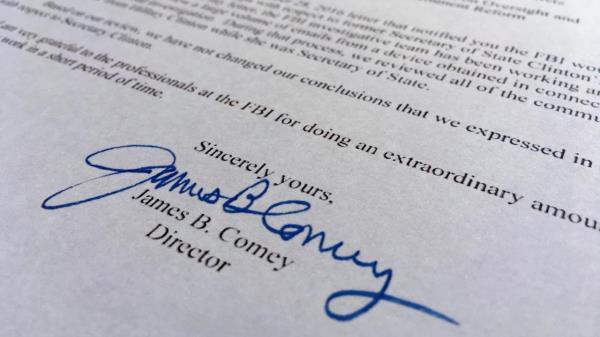 FILE - Part of a Nov. 6, 2016, letter from FBI Director James Comey to Co<em></em>ngress is photographed in Washington on Nov. 6, 2016. Comey told Co<em></em>ngress that a review of new Hillary Clinton emails has 