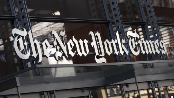 FILE - A sign for The New York Times hangs above the entrance to its building, May 6, 2021, in New York. The Athletic, a subs<em></em>cription sports outlet owned by The New York Times, is laying off a<em></em>bout 4% of its newsroom staff as part of reorganization efforts, the company co<em></em>nfirmed on Monday, June 12, 2023. (AP Photo/Mark Lennihan, File)