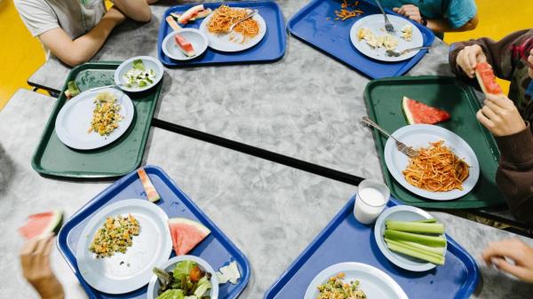 FILE -- Students eat lunch at a middle school in Boulder, Colo., Aug. 25, 2017. Warwick Public Schools in Rhode Island is limiting lunch options for children in debt to one item, reigniting a natio<em></em>nal debate over 