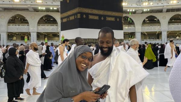 Somalian pilgrims prepare for a selfie in front of the Kaaba, the cubic building at the Grand Mosque, during the annual hajj pilgrimage in Mecca, Saudi Arabia, Monday, June 26, 2023, before heading to Mina in preparation for the Hajj, the fifth pillar of Islam and one of the largest religious gatherings in the world. (AP Photo/Amr Nabil)