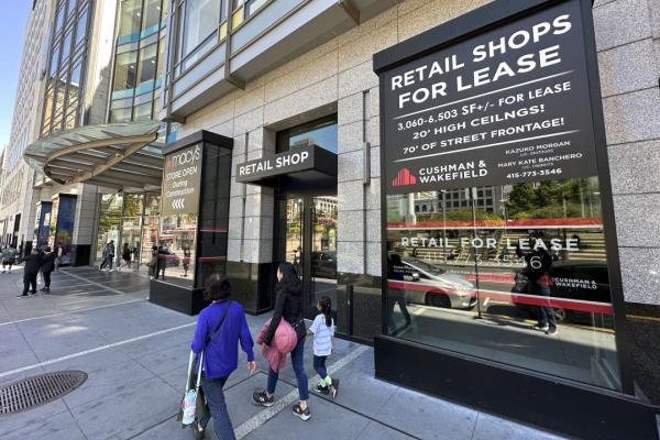 People make their way past retail spaces for lease at Unio<em></em>n Square in San Francisco, on June 21, 2023. San Francisco's downtown has seen an exodus of retailers and now a shopping mall owner is turning the complex over to its lender in the face of declining foot traffic and empty office space. While San Francisco faces some of its own unique issues, such as a heavy reliance on tech workers, most of them working largely remotely, the problems serve as warning signs for other downtowns across the country, which are also feeling some pain. (AP Photo/Eric Risberg)