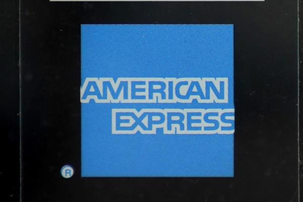 FILE - An American Express logo is attached to a door in Boston's Seaport District, Wednesday, July 21, 2021. American Express earnings are reported on Friday. (AP Photo/Steven Senne, File)