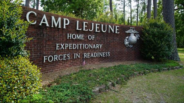 FILE - Signage stands on the main gate to Camp Lejeune Marine ba<em></em>se outside Jacksonville, N.C., Friday, April 29, 2022. Three men who were found dead over the weekend at an eastern North Carolina gas station have been identified as Marine lance corporals statio<em></em>ned nearby at Camp Lejeune, the U.S. Marine Corps said Tuesday, July 25, 2023. (AP Photo/Allen G. Breed, File)