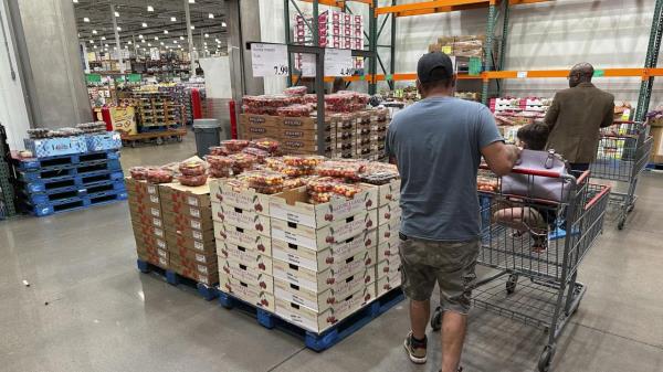 Shoppers peruse a display of Rainer cherries at a Costco warehouse Tuesday, July 11, 2023, in Sheridan, Colo. On Friday, The Commerce Department issues its June report on co<em></em>nsumer spending. (AP Photo/David Zalubowski)