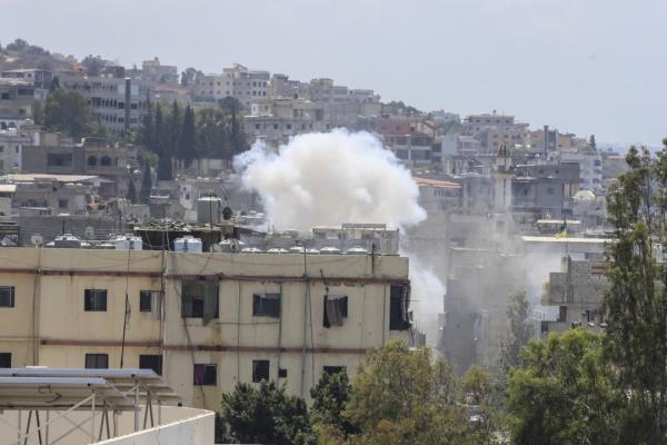 Smoke rises during a clashes that erupted between members of the Palestinian Fateh group and Islamist militants in the Palestinian refugee camp of Ein el-Hilweh near the southern port city of Sidon, Lebanon, Sunday, July 30, 2023. Palestinian officials say at least five people have been killed and several others wounded during clashes in Lebanon’s largest Palestinian refugee camp. (AP Photo/Mohammad Zaatari)