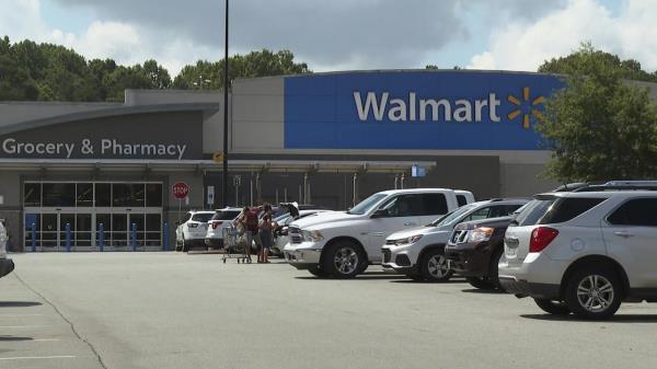 In this image taken from video, shoppers load purchased items into their vehicle Monday, July 31, 2023, at a Walmart in Lincolnton, N.C., wher<em></em>e police say migrant workers were intentio<em></em>nally hit by an SUV in the parking lot of the store a day earlier. (AP Photo/Erik Verduzco)